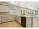 Open-concept kitchen featuring an island with a sink and dishwasher at 3609 Kingfishers Catch Ave, North Las Vegas, NV 89084