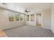 Bright living room with three large windows, recessed lighting, ceiling fan and carpet flooring at 3609 Kingfishers Catch Ave, North Las Vegas, NV 89084