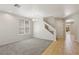 Carpeted living room next to tiled entryway and staircase at 3609 Kingfishers Catch Ave, North Las Vegas, NV 89084