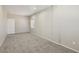 A large, open living room features neutral colors, carpet flooring, and one window at 3609 Kingfishers Catch Ave, North Las Vegas, NV 89084