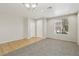Bright living room featuring tile and carpet flooring and a large window at 3609 Kingfishers Catch Ave, North Las Vegas, NV 89084