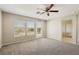 Upstairs loft area featuring neutral carpeting, a ceiling fan, and balcony access at 3609 Kingfishers Catch Ave, North Las Vegas, NV 89084