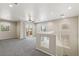 Bright open loft features neutral walls and carpet flooring, a sliding glass door, and two windows at 3609 Kingfishers Catch Ave, North Las Vegas, NV 89084