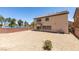 Spacious gravel backyard is ready for landscaping with lake views in the background at 3941 Copper Stone Ct, North Las Vegas, NV 89032