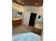 Spacious bathroom with double sinks, wood cabinetry, a soaking tub, and a closet at 3941 Copper Stone Ct, North Las Vegas, NV 89032