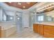 A spacious bathroom with tub, shower, and double sink vanity featuring wood-look floors at 3941 Copper Stone Ct, North Las Vegas, NV 89032