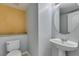 A half bathroom showcasing a pedestal sink, toilet, and neutral color scheme at 3941 Copper Stone Ct, North Las Vegas, NV 89032