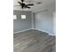 Cozy bedroom with neutral walls, gray wood-look flooring, and a ceiling fan at 3941 Copper Stone Ct, North Las Vegas, NV 89032
