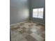 Bright bedroom showcasing tile flooring and a window with neighborhood views at 3941 Copper Stone Ct, North Las Vegas, NV 89032
