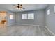 A spacious bedroom featuring light gray walls, a ceiling fan, and wood-look flooring at 3941 Copper Stone Ct, North Las Vegas, NV 89032