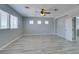 A spacious bonus room featuring neutral gray walls, wood-look floors, three windows and a ceiling fan at 3941 Copper Stone Ct, North Las Vegas, NV 89032