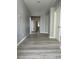Hallway with gray wood-look floors, neutral colored walls, and white trim at 3941 Copper Stone Ct, North Las Vegas, NV 89032