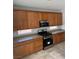 Kitchen with dark stainless steel range and microwave plus lots of wooden cabinets at 3941 Copper Stone Ct, North Las Vegas, NV 89032