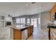 Bright kitchen featuring an island, stainless steel appliances, and an open layout with the living room at 3941 Copper Stone Ct, North Las Vegas, NV 89032