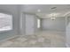 Inviting room showcases neutral walls, tile flooring, contemporary lighting, and ample natural light at 3941 Copper Stone Ct, North Las Vegas, NV 89032