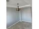 Cozy living room with modern lighting fixture, tile flooring, and neutral walls at 3941 Copper Stone Ct, North Las Vegas, NV 89032
