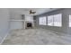 Bright living room featuring tile floors, a fireplace, and large windows allowing ample sunlight at 3941 Copper Stone Ct, North Las Vegas, NV 89032