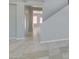 Open space with tile floor, ready for furnishings, with stairs visible at 3941 Copper Stone Ct, North Las Vegas, NV 89032