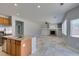 Open-concept kitchen and living room with tile flooring, a fireplace, and stainless steel appliances at 3941 Copper Stone Ct, North Las Vegas, NV 89032