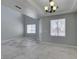 Spacious area boasting stylish tile floor, two windows, and a modern light, creating a welcoming environment at 3941 Copper Stone Ct, North Las Vegas, NV 89032
