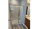 Bathroom featuring a glass enclosed shower with white tiling and chrome fixtures at 3941 Copper Stone Ct, North Las Vegas, NV 89032