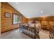 Inviting bedroom with log walls and a window at 401 Alpine Way, Mount Charleston, NV 89124