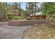 Log cabin home with brick retaining wall, offering rustic charm and curb appeal in a wooded setting at 401 Alpine Way, Mount Charleston, NV 89124