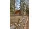 Woodsy cabin with a well-maintained brick retaining wall and lush surroundings at 401 Alpine Way, Mount Charleston, NV 89124