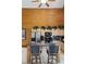 Charming kitchen featuring granite countertops, bar seating, wooden cabinets and high ceilings with a fan at 401 Alpine Way, Mount Charleston, NV 89124