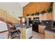 Bright kitchen with granite countertops, wooden cabinets, bar seating and a connecting staircase at 401 Alpine Way, Mount Charleston, NV 89124