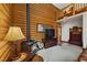 Bright and airy living area with log walls, a wood stove, and an open floor plan leading to the kitchen at 401 Alpine Way, Mount Charleston, NV 89124