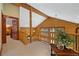 Open loft area features log walls, a beamed ceiling, and railing overlooking the downstairs at 401 Alpine Way, Mount Charleston, NV 89124