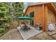 Relaxing outdoor patio with a grill and seating area, designed for comfortable outdoor living amidst nature's beauty at 401 Alpine Way, Mount Charleston, NV 89124