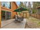 Inviting outdoor patio with seating and grill, perfect for relaxing and entertaining surrounded by lush greenery at 401 Alpine Way, Mount Charleston, NV 89124
