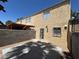 View of the back of the property with fenced-in patio, exterior door, and gravel landscaping at 453 Las Casitas Way, Las Vegas, NV 89121