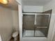 Bathroom showcasing tiled shower with glass door, toilet, and modern fixtures at 453 Las Casitas Way, Las Vegas, NV 89121