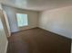 Spacious bedroom with carpet, bright window and a door to the hallway at 453 Las Casitas Way, Las Vegas, NV 89121