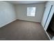 Well-lit bedroom features neutral carpet, a bright window and a closet with sliding doors at 453 Las Casitas Way, Las Vegas, NV 89121