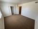Spacious bedroom boasts neutral carpeting, sliding closet doors, and a door to hallway at 453 Las Casitas Way, Las Vegas, NV 89121