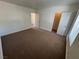 Carpeted bedroom with door, bright window and a neutral color scheme at 453 Las Casitas Way, Las Vegas, NV 89121