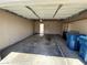 Attached two car garage with storage shelves and blue trash cans at 453 Las Casitas Way, Las Vegas, NV 89121