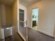 Bright hallway leading to a full bathroom with wood floors and a door to the lower level of the home at 453 Las Casitas Way, Las Vegas, NV 89121
