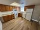 The kitchen has wood-look floors, a window over the sink, and appliances in white at 453 Las Casitas Way, Las Vegas, NV 89121