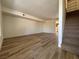 Bright living room boasts wood-look floors and staircase access to the upper level of the home at 453 Las Casitas Way, Las Vegas, NV 89121