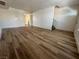Spacious living room with ample natural light showcases the attractive wood-look flooring at 453 Las Casitas Way, Las Vegas, NV 89121
