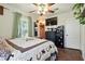 Comfortable bedroom featuring a ceiling fan, warm lighting, and exterior view at 517 5Th St, Boulder City, NV 89005