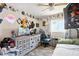 A decorated bedroom with single bed and gaming setup offers comfort and fun at 517 5Th St, Boulder City, NV 89005