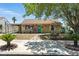 This lovely home features a quaint, covered carport, inviting front yard, and a charming, vibrant blue front door at 517 5Th St, Boulder City, NV 89005