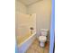 This bathroom showcases a standard toilet and a combined shower and bathtub with tile flooring at 5215 Gray Ln, Las Vegas, NV 89119