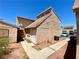 Exterior view of home with brick and siding, plus walkways and desert landscaping and parked cars at 5215 Gray Ln, Las Vegas, NV 89119